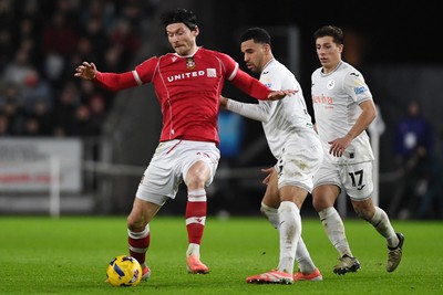 191225 - Swansea City v Wrexham - Sky Bet Championship - Kieffer Moore of Wrexham is challenged by Ben Cabango of Swansea City