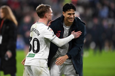 191225 - Swansea City v Wrexham - Sky Bet Championship - Ethan Galbraith of Swansea City celebrates the win at full time with Marko Stamenic of Swansea City