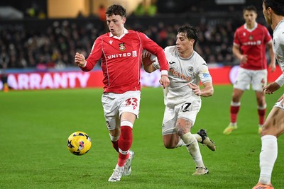 191225 - Swansea City v Wrexham - Sky Bet Championship - Goncalo Franco of Swansea City is challenged by Nathan Broadhead of Wrexham