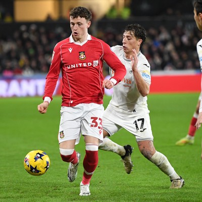 191225 - Swansea City v Wrexham - Sky Bet Championship - Goncalo Franco of Swansea City is challenged by Nathan Broadhead of Wrexham