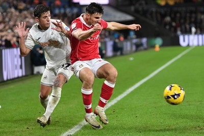 191225 - Swansea City v Wrexham - Sky Bet Championship - Goncalo Franco of Swansea City is challenged by Max Cleworth of Wrexham