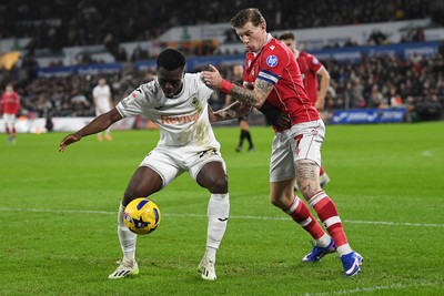 191225 - Swansea City v Wrexham - Sky Bet Championship - Zeidane Inoussa of Swansea City is challenged by James McClean of Wrexham