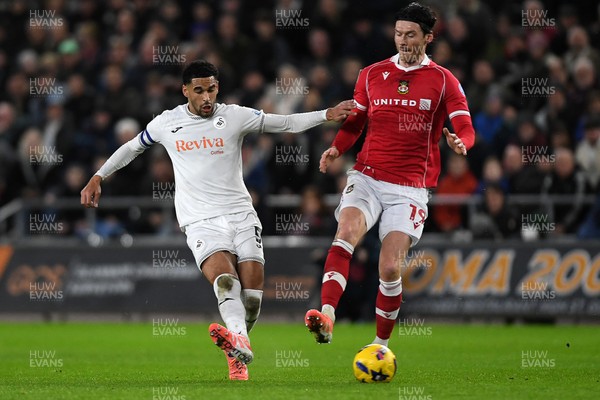 191225 - Swansea City v Wrexham - Sky Bet Championship - Kieffer Moore of Wrexham is challenged by Ben Cabango of Swansea City