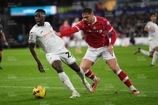 191225 - Swansea City v Wrexham - Sky Bet Championship - Zeidane Inoussa of Swansea City is challenged by Callum Doyle of Wrexham