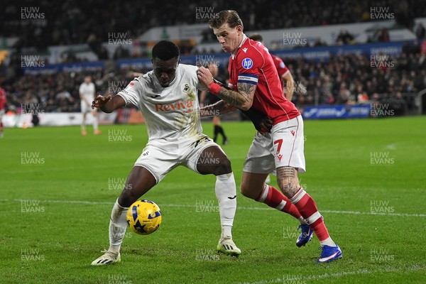 191225 - Swansea City v Wrexham - Sky Bet Championship - Zeidane Inoussa of Swansea City is challenged by James McClean of Wrexham