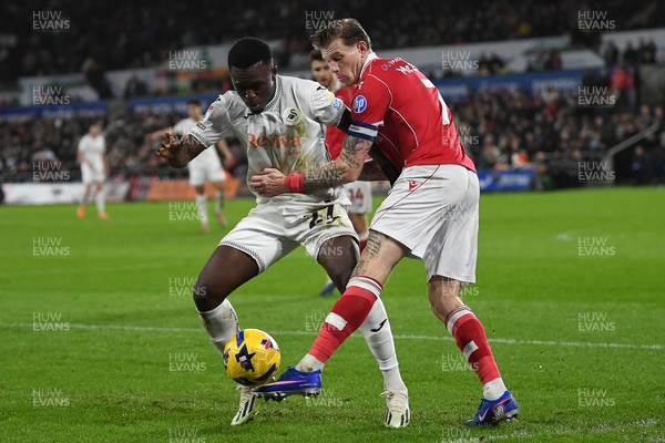 191225 - Swansea City v Wrexham - Sky Bet Championship - Zeidane Inoussa of Swansea City is challenged by James McClean of Wrexham