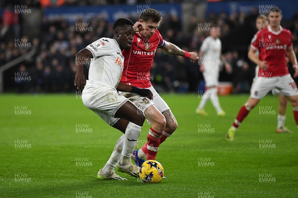 191225 - Swansea City v Wrexham - Sky Bet Championship - Zeidane Inoussa of Swansea City is challenged by James McClean of Wrexham
