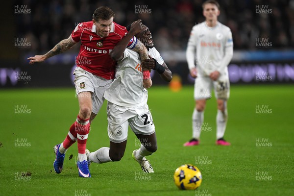 191225 - Swansea City v Wrexham - Sky Bet Championship - Zeidane Inoussa of Swansea City is challenged by James McClean of Wrexham