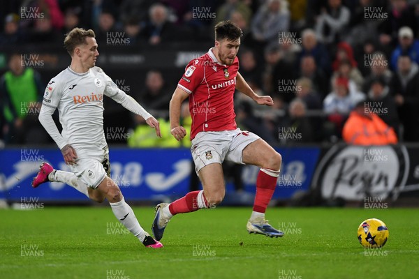 191225 - Swansea City v Wrexham - Sky Bet Championship - George Thomason of Wrexham is challenged by Ethan Galbraith of Swansea City