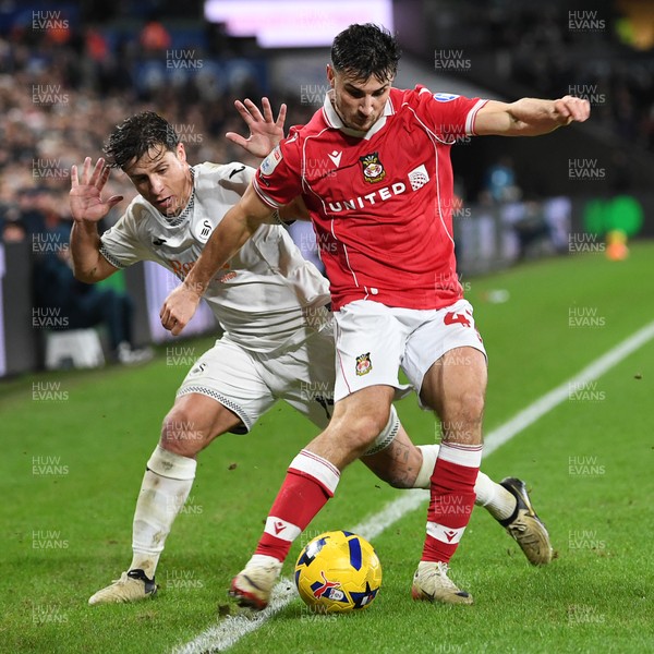 191225 - Swansea City v Wrexham - Sky Bet Championship - Goncalo Franco of Swansea City is challenged by Max Cleworth of Wrexham