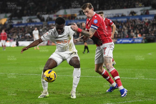 191225 - Swansea City v Wrexham - Sky Bet Championship - Zeidane Inoussa of Swansea City is challenged by James McClean of Wrexham