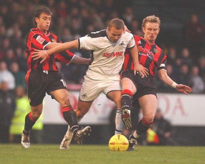 010105 - Swansea City v Yeovil Town - Swansea's Lee Trundle tries to force a way through Andy Lindgaard (L) and Scott Guyett