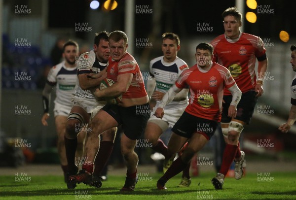 110117 - Swansea RFC v Llanelli RFC - Fosters Cup - Craig Thomas of Llanelli is tackled by Rory Gallagher of Swansea by Chris Fairweather/Huw Evans Agency