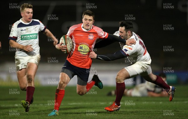 110117 - Swansea RFC v Llanelli RFC - Fosters Cup - Ioan Hughes of Llanelli is tackled by Richard Williams of Swansea by Chris Fairweather/Huw Evans Agency