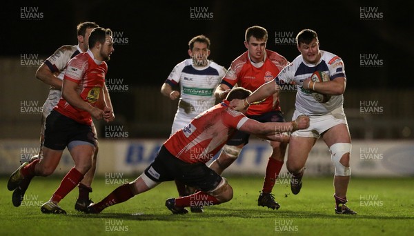 110117 - Swansea RFC v Llanelli RFC - Fosters Cup - Jonathan Fox of Swansea is tackled by Elliott Rees of Llanelli by Chris Fairweather/Huw Evans Agency