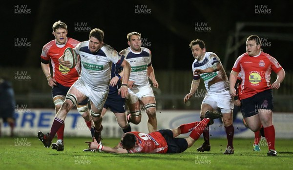 110117 - Swansea RFC v Llanelli RFC - Fosters Cup - Tudor Hughes of Swansea is tackled by Matthew Flanagan of Llanelli by Chris Fairweather/Huw Evans Agency