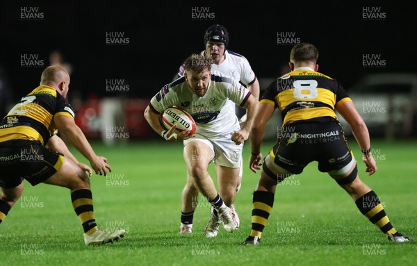 021025 - Swansea RFC v Newport RFC, Super Rygbi Cymru - Callum Bowden of Swansea takes on Henry Palmer of Newport and Cerrig Smith of Newport