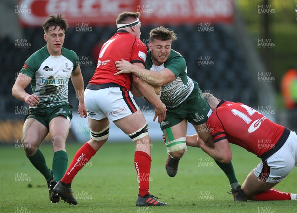 250418 - Swansea University v Cardiff University, Welsh Varsity rugby match - Matthew Pearce of Swansea University is tackled by Harry Griffiths of Cardiff University and Alex Everett of Cardiff University