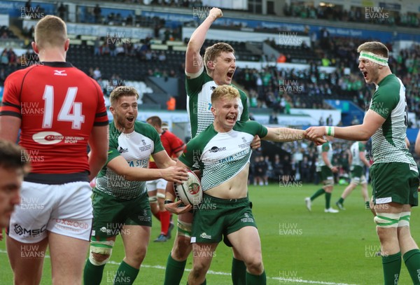 250418 - Swansea University v Cardiff University, Welsh Varsity rugby match - Hywel Williams of Swansea University celebrates with team mates after Swansea score the first try