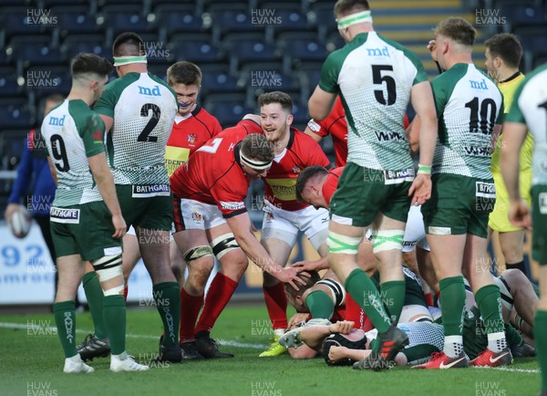 250418 - Swansea University v Cardiff University, Welsh Varsity rugby match - Cardiff University celebrate as they power over to score try