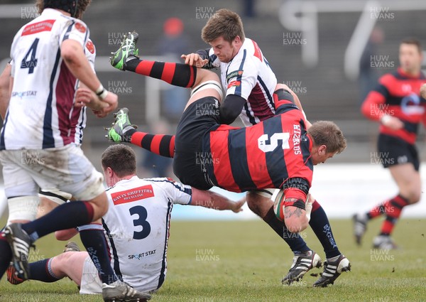 230313 - Swansea v Aberavon - SWALEC Cup Quarter Final -Sam Williams of Aberavon is tackled by Ian Williams and Matthew Davies of Swansea 