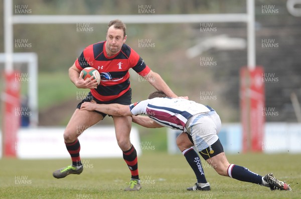 230313 - Swansea v Aberavon - SWALEC Cup Quarter Final - Paul Bamsey of Aberavon is tackled by Chris Shelmerdine of Swansea 