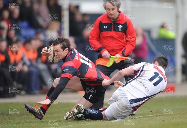 230313 - Swansea v Aberavon - SWALEC Cup Quarter Final -Richard Carter of Aberavon is tackled by Rhys Williams of Swansea 