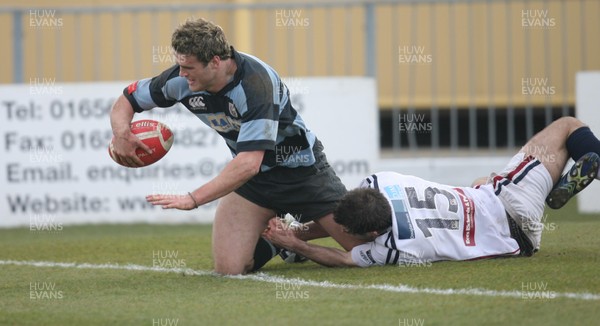 25.03.07..Cardiff v Swansea, Konica Minolta Cup Quarter Final Cardiff's Jamie Roberts beats his opposite number Ricky Williams to score try 