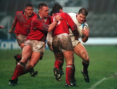 101294 - Swansea v Llanelli - Sean Marshall of Swansea is tackled by Huw Harries