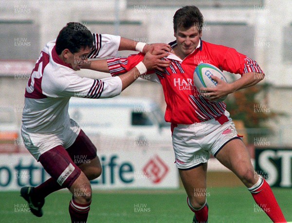 180993 - Swansea v Llanelli - Heineken League -  Neil Boobyer is tackled by Jason Ball 