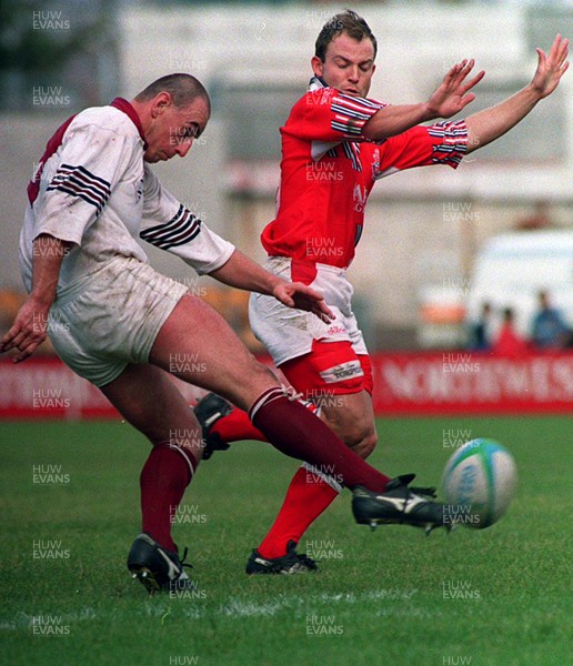 180993 - Swansea v Llanelli - Heineken League -  Alan Reynolds of Swansea kicks past Ian Jones 