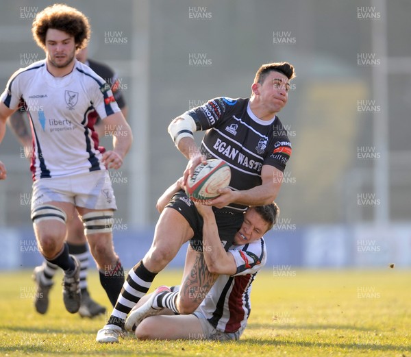 020313 - Swansea v Pontypridd - Principality Premiership -Gareth James of Pontypridd is tackled by Jamie Thomas of Swansea