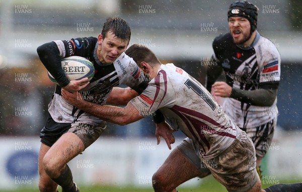 090116 - Swansea RFC v Pontypridd - SWALEC Cup - Lewis Williams of Pontypridd is tackled by Jed Evans of Swansea