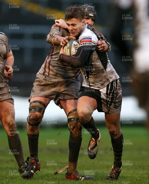 090116 - Swansea RFC v Pontypridd - SWALEC Cup - Lewis Williams of Pontypridd is tackled by Sam Kelly of Swansea