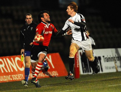 12.03.10 - Principality Premiership Rugby, Swansea v Pontypridd Ponty's Gavin Dacey looks for support as Jamie Dixon tackles 