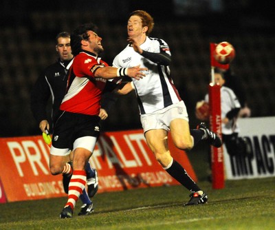 12.03.10 - Principality Premiership Rugby, Swansea v Pontypridd Ponty's Gavin Dacey looks for support as Jamie Dixon tackles 