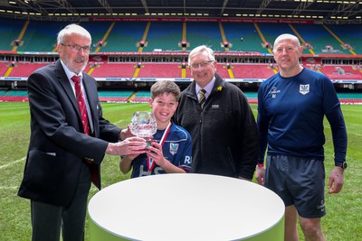 210324 - Swansea Valley v Mynydd Mawr - Welsh Schools Junior Group U11 DC Thomas Bowl Final -  Idris Power of the WRU hands the trophy to the Mynydd Mawr captain alongside Roy Bergiers and Roy James of MMAD 