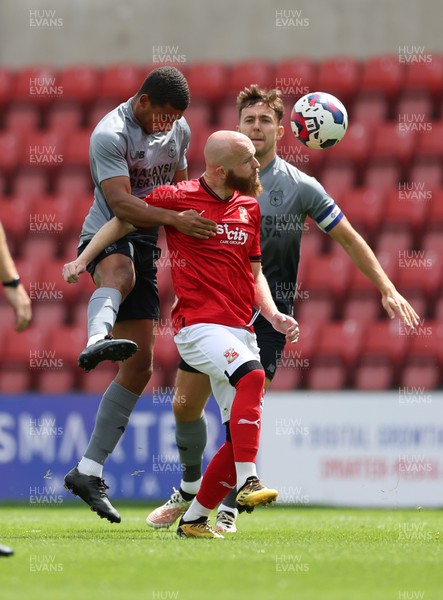 230722 - Swindon Town v Cardiff City, Pre-season Friendly - Andy Rinomhota of Cardiff City and Jonny Williams of Swindon Town compete for the ball