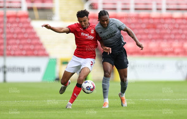 230722 - Swindon Town v Cardiff City, Pre-season Friendly - Mahlon Romeo of Cardiff City and Remeao Hutton of Swindon Town compete for the ball