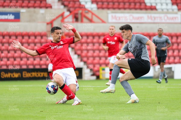 230722 - Swindon Town v Cardiff City, Pre-season Friendly - Callum O'Dowda of Cardiff City has his shot at goal blocked by Mathieu Baudry of Swindon Town