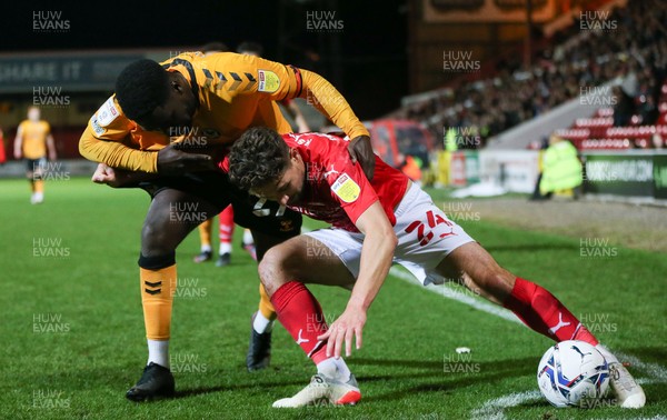 091121 - Swindon Town v Newport County, EFL Papa John's Trophy - Chris Missilou of Newport County puts pressure on Rob Hunt of Swindon Town as he looks to win the ball