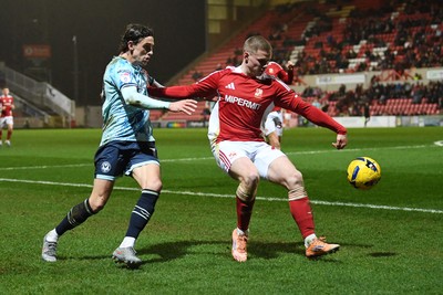 110226 - Swindon Town v Newport County - Sky Bet League 2 - Harrison Biggins of Newport County is challenged by Jake Batty of Swindon