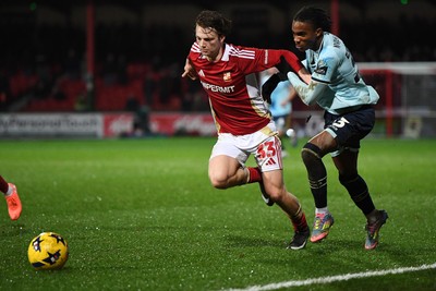 110226 - Swindon Town v Newport County - Sky Bet League 2 - Tanatswa Nyakuhwa of Newport County is challenged by Joel McGregor of Swindon