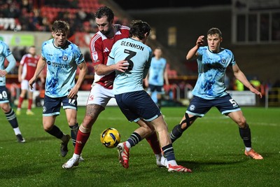 110226 - Swindon Town v Newport County - Sky Bet League 2 - Anthony Glennon of Newport County is challenged by Ollie Palmer of Swindon