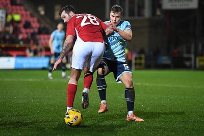 110226 - Swindon Town v Newport County - Sky Bet League 2 - Sven Sprangler of Newport County is challenged by Ollie Palmer of Swindon