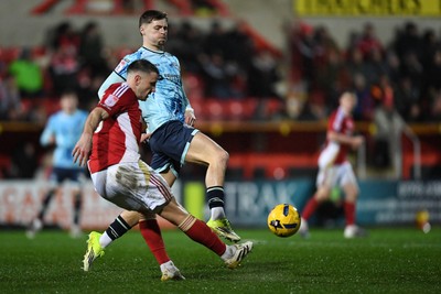 110226 - Swindon Town v Newport County - Sky Bet League 2 - James Crole of Newport County is challenged by James Ball of Swindon