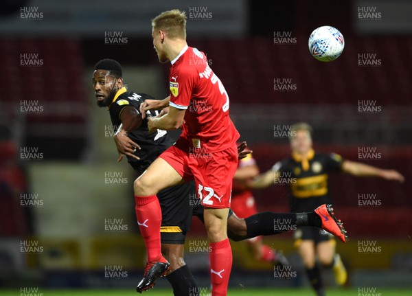 110918 - Swindon Town v Newport County - Checkatrade Trophy - Jamille Matt of Newport County competes with Steven Alzate of Swindon Town