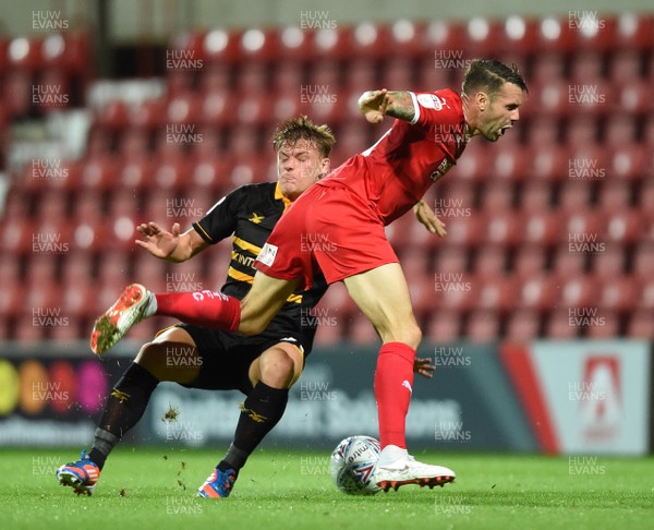 110918 - Swindon Town v Newport County - Checkatrade Trophy - James Dunne of Swindon Town is tackled by Cameron Pring of Newport County
