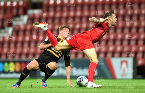 110918 - Swindon Town v Newport County - Checkatrade Trophy - James Dunne of Swindon Town is tackled by Cameron Pring of Newport County
