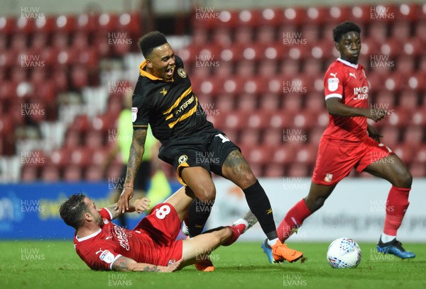110918 - Swindon Town v Newport County - Checkatrade Trophy - Keanu Marsh-Brown of Newport County is tackled by James Dunne of Swindon Town